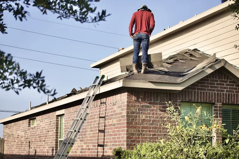 Professional roofer working on a residential roof in Broadmoor Hills